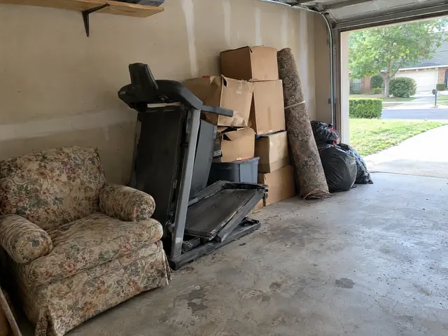 The customer’s photo of a garage with an armchair, a treadmill and boxes.